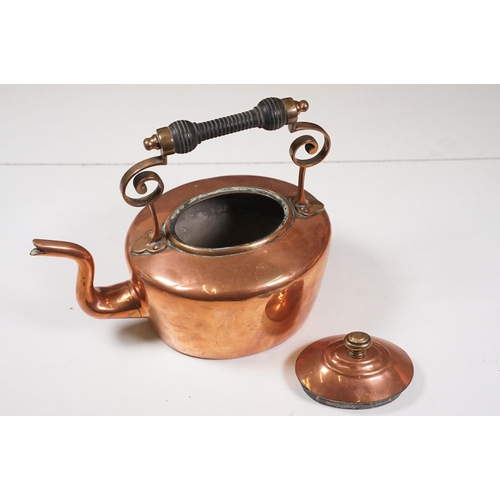 424 - Two Late 19th Century copper teapots, one with turned wooden handle