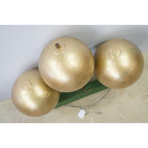 466 - 1950s pawn brokers painted glass golden balls on wooden hanger, together with a painted District Lin... 