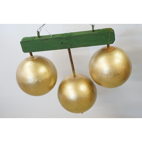 466 - 1950s pawn brokers painted glass golden balls on wooden hanger, together with a painted District Lin... 