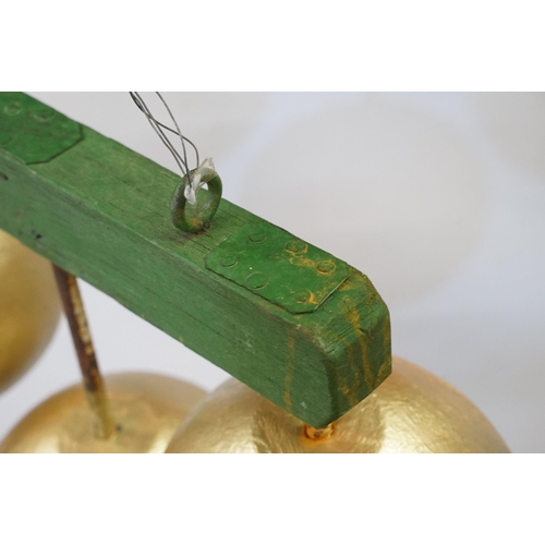 466 - 1950s pawn brokers painted glass golden balls on wooden hanger, together with a painted District Lin... 