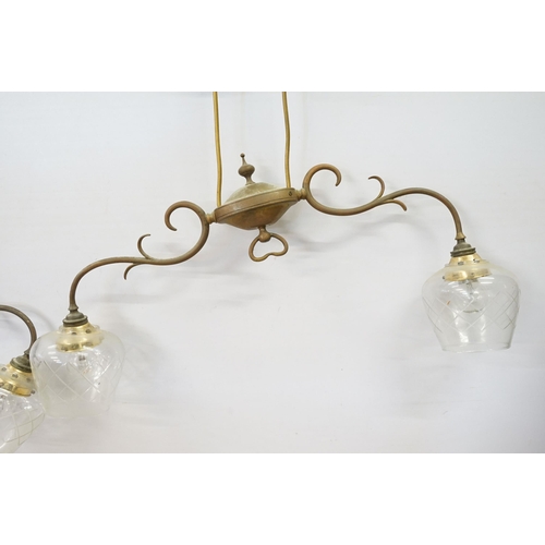 469 - Three early 20th Century rise and fall hall lights, each having two scrolled arms with cut glass sco... 