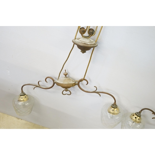469 - Three early 20th Century rise and fall hall lights, each having two scrolled arms with cut glass sco... 