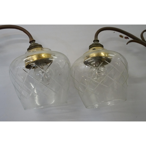 469 - Three early 20th Century rise and fall hall lights, each having two scrolled arms with cut glass sco... 
