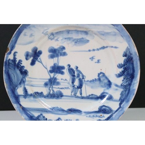 12 - 18th century delft ware plate with blue and white design of a walking couple within a scenic view, d... 
