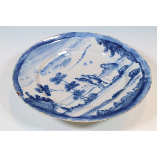 12 - 18th century delft ware plate with blue and white design of a walking couple within a scenic view, d... 