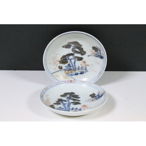 53 - Two Chinese The Nanking Cargo ceramic tea cup and saucers with blue and white scenes and detailed de... 