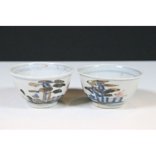 53 - Two Chinese The Nanking Cargo ceramic tea cup and saucers with blue and white scenes and detailed de... 