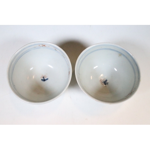 53 - Two Chinese The Nanking Cargo ceramic tea cup and saucers with blue and white scenes and detailed de... 
