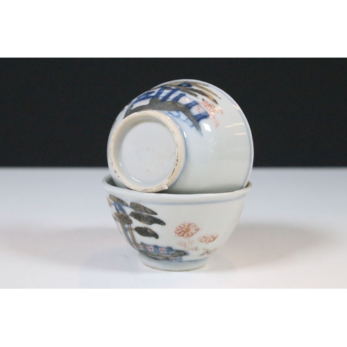 53 - Two Chinese The Nanking Cargo ceramic tea cup and saucers with blue and white scenes and detailed de... 