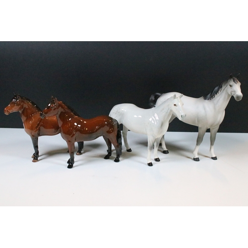54 - Group of four Beswick horse figurines to include Dartmoor, Warlord and a white pony example in a hig... 
