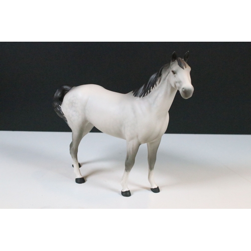 54 - Group of four Beswick horse figurines to include Dartmoor, Warlord and a white pony example in a hig... 