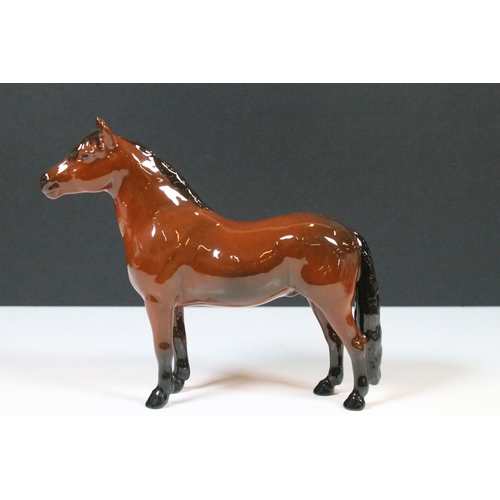 54 - Group of four Beswick horse figurines to include Dartmoor, Warlord and a white pony example in a hig... 