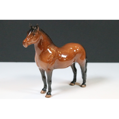 54 - Group of four Beswick horse figurines to include Dartmoor, Warlord and a white pony example in a hig... 