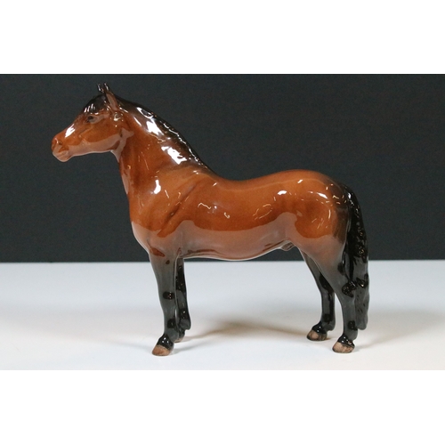 54 - Group of four Beswick horse figurines to include Dartmoor, Warlord and a white pony example in a hig... 