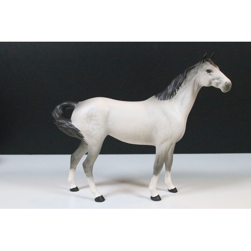 54 - Group of four Beswick horse figurines to include Dartmoor, Warlord and a white pony example in a hig... 