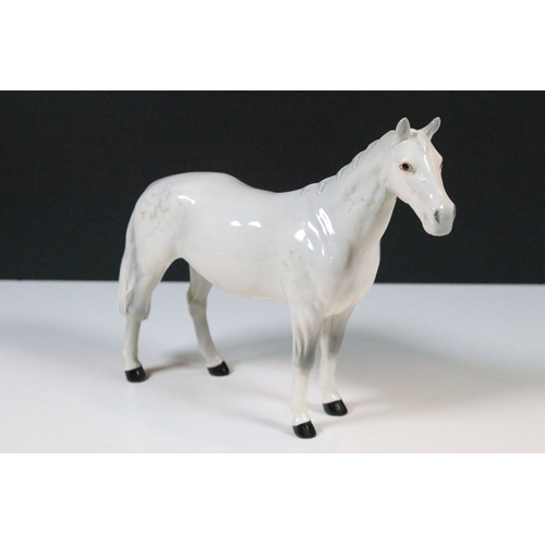 54 - Group of four Beswick horse figurines to include Dartmoor, Warlord and a white pony example in a hig... 