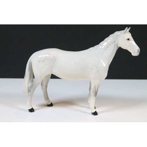54 - Group of four Beswick horse figurines to include Dartmoor, Warlord and a white pony example in a hig... 