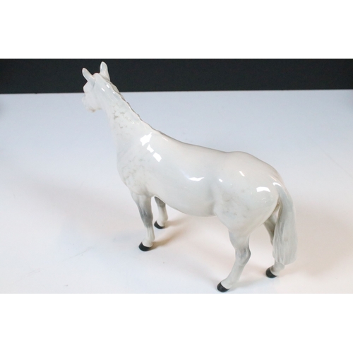 54 - Group of four Beswick horse figurines to include Dartmoor, Warlord and a white pony example in a hig... 