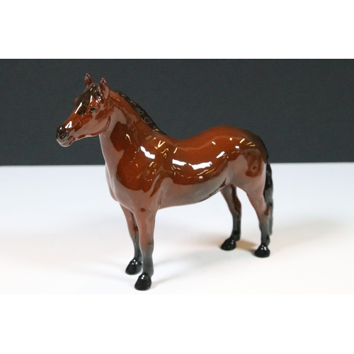 54 - Group of four Beswick horse figurines to include Dartmoor, Warlord and a white pony example in a hig... 