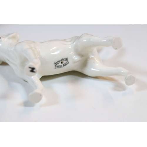 7 - Beswick hunt figurines to include huntsman, huntswoman and seven hounds (9)