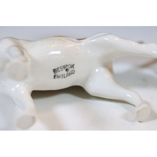 7 - Beswick hunt figurines to include huntsman, huntswoman and seven hounds (9)