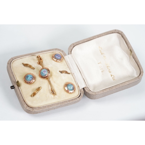 56 - Set of Arts and Crafts dress studs being set with ceramic blue cabochons (gold plated unmarked) toge... 