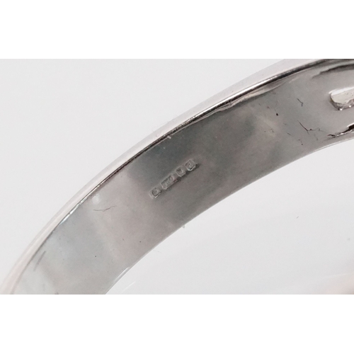 149 - 18ct gold red Andesine feldspar and diamond dress ring. The ring being set with an oval red a Andesi... 