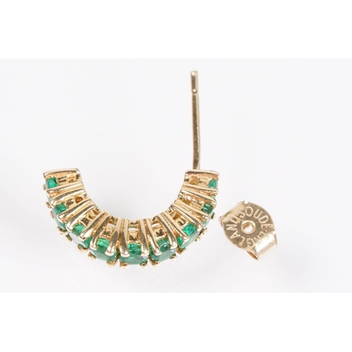 153 - Pair of 14ct gold and emerald half hoop earrings being set with nine round cut emeralds. Marked 14k.... 