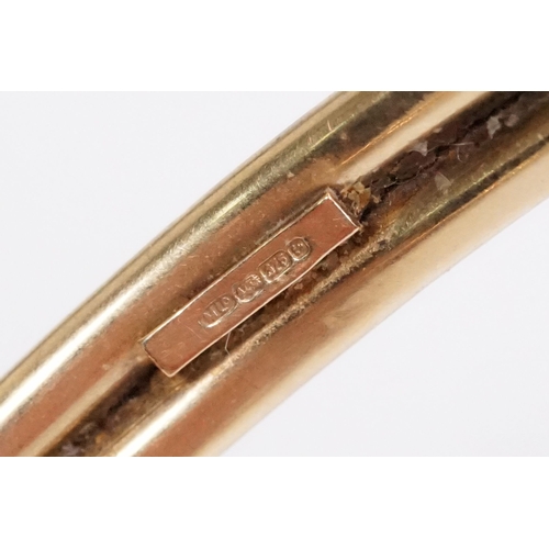 156 - 9ct gold bangle bracelet having ball terminals. Hallmarked Birmingham. Measures 2.5 inches.