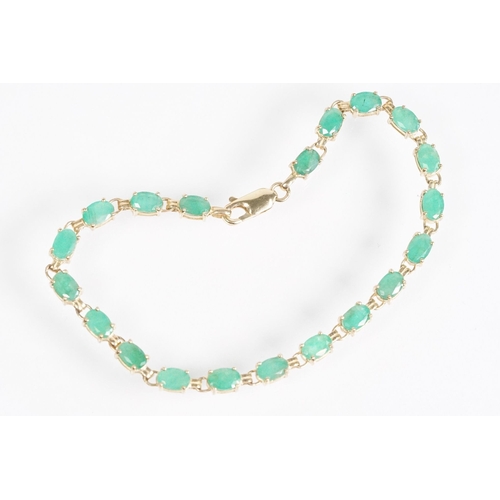 162 - 9ct gold and emerald line bracelet with lobster clasp. Clasp marked 375. Bracelet measures 8 inches.