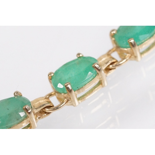 162 - 9ct gold and emerald line bracelet with lobster clasp. Clasp marked 375. Bracelet measures 8 inches.
