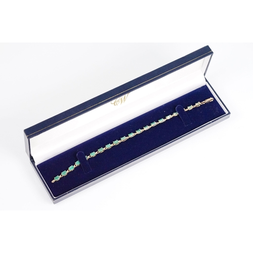 162 - 9ct gold and emerald line bracelet with lobster clasp. Clasp marked 375. Bracelet measures 8 inches.