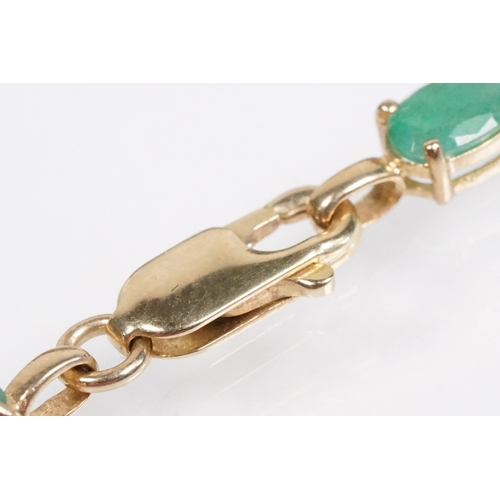 162 - 9ct gold and emerald line bracelet with lobster clasp. Clasp marked 375. Bracelet measures 8 inches.