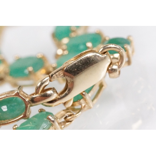 162 - 9ct gold and emerald line bracelet with lobster clasp. Clasp marked 375. Bracelet measures 8 inches.