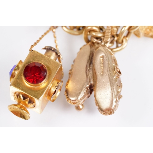 163 - 18ct gold charm bracelet having a curb link chain and spring ring clasp (marked 750), traffic light ... 