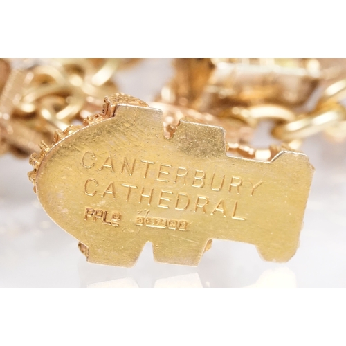 163 - 18ct gold charm bracelet having a curb link chain and spring ring clasp (marked 750), traffic light ... 