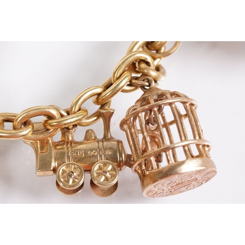 163 - 18ct gold charm bracelet having a curb link chain and spring ring clasp (marked 750), traffic light ... 
