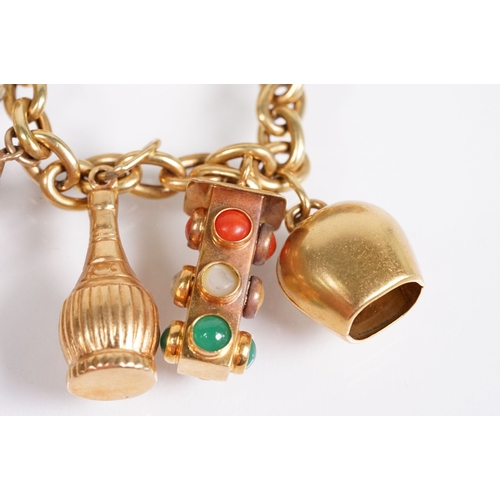 163 - 18ct gold charm bracelet having a curb link chain and spring ring clasp (marked 750), traffic light ... 