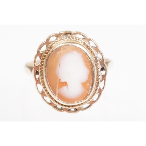 168 - 9ct gold cameo ring being set with an oval carved shell cameo. Hallmarked London 1967, size L.