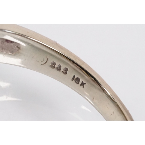 172 - 18ct gold, ruby and sapphire three stone ring. The ring being set with a marquise cut sapphire to ce... 