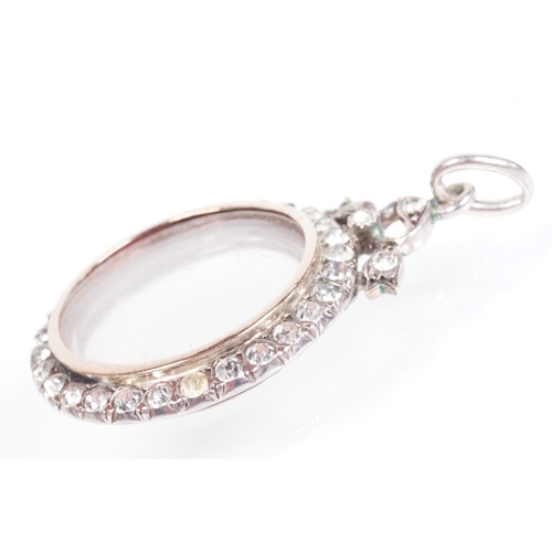 173 - Early 20th Century Edwardian silver and paste locket of round form set with round cut paste stones w... 