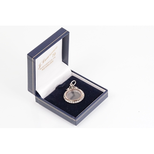 173 - Early 20th Century Edwardian silver and paste locket of round form set with round cut paste stones w... 