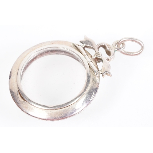 173 - Early 20th Century Edwardian silver and paste locket of round form set with round cut paste stones w... 