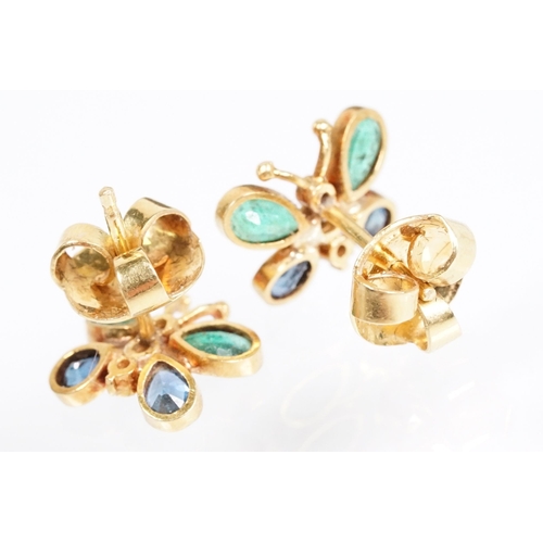 24 - Pair of emerald, sapphire and diamond butterfly stud earrings, each set with two emerald and sapphir... 