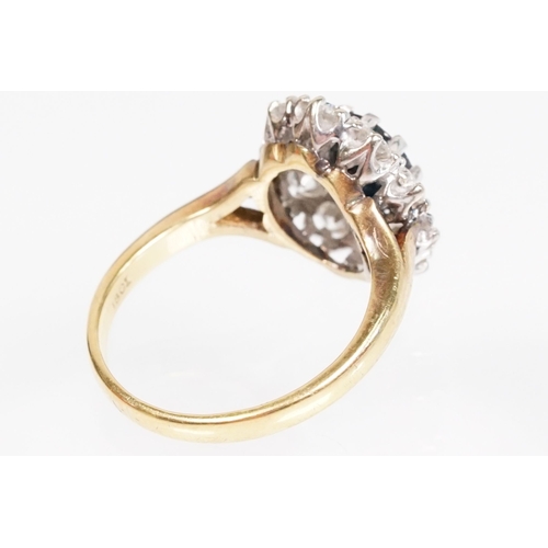 7 - 18ct gold sapphire and diamond halo ring. The ring being set with an oval mixed cut blue sapphire wi... 