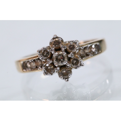 174 - 9ct gold and diamond cluster ring. The ring being set with a central cluster of round brilliant cut ... 