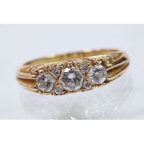 180 - 18ct gold and diamond ring, set with three principle round brilliant cut diamonds with a further fou... 