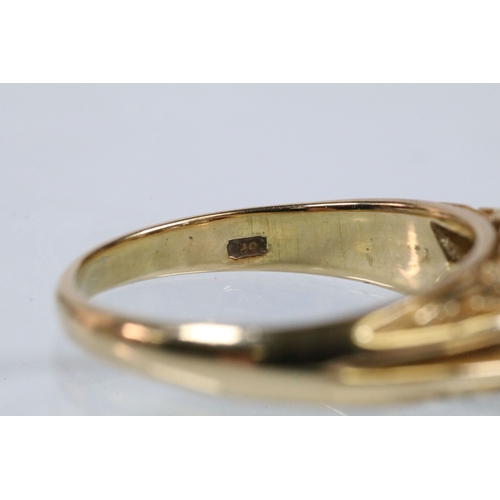 180 - 18ct gold and diamond ring, set with three principle round brilliant cut diamonds with a further fou... 