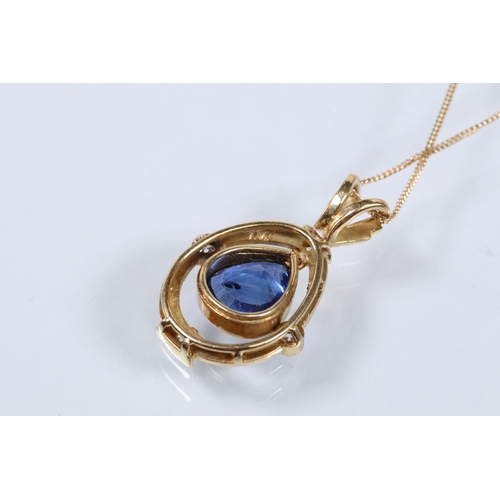 6 - 18ct gold, sapphire and diamond pendant necklace. The necklace being bezel set with a mixed pear cut... 