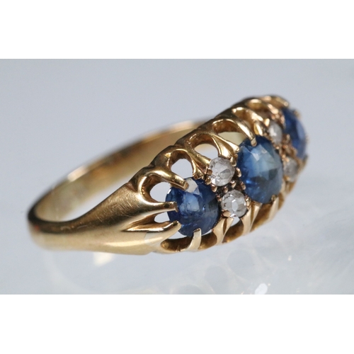 17 - 18ct gold, sapphire and diamond ring being set with three round cut blue sapphires with four diamond... 